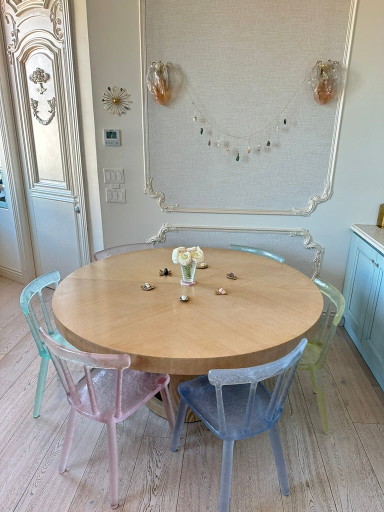 Rainbow Healing Crystal Garland draped between two sconces in a dining room, raw crystals hanging from a gold chain like a necklace for the wall