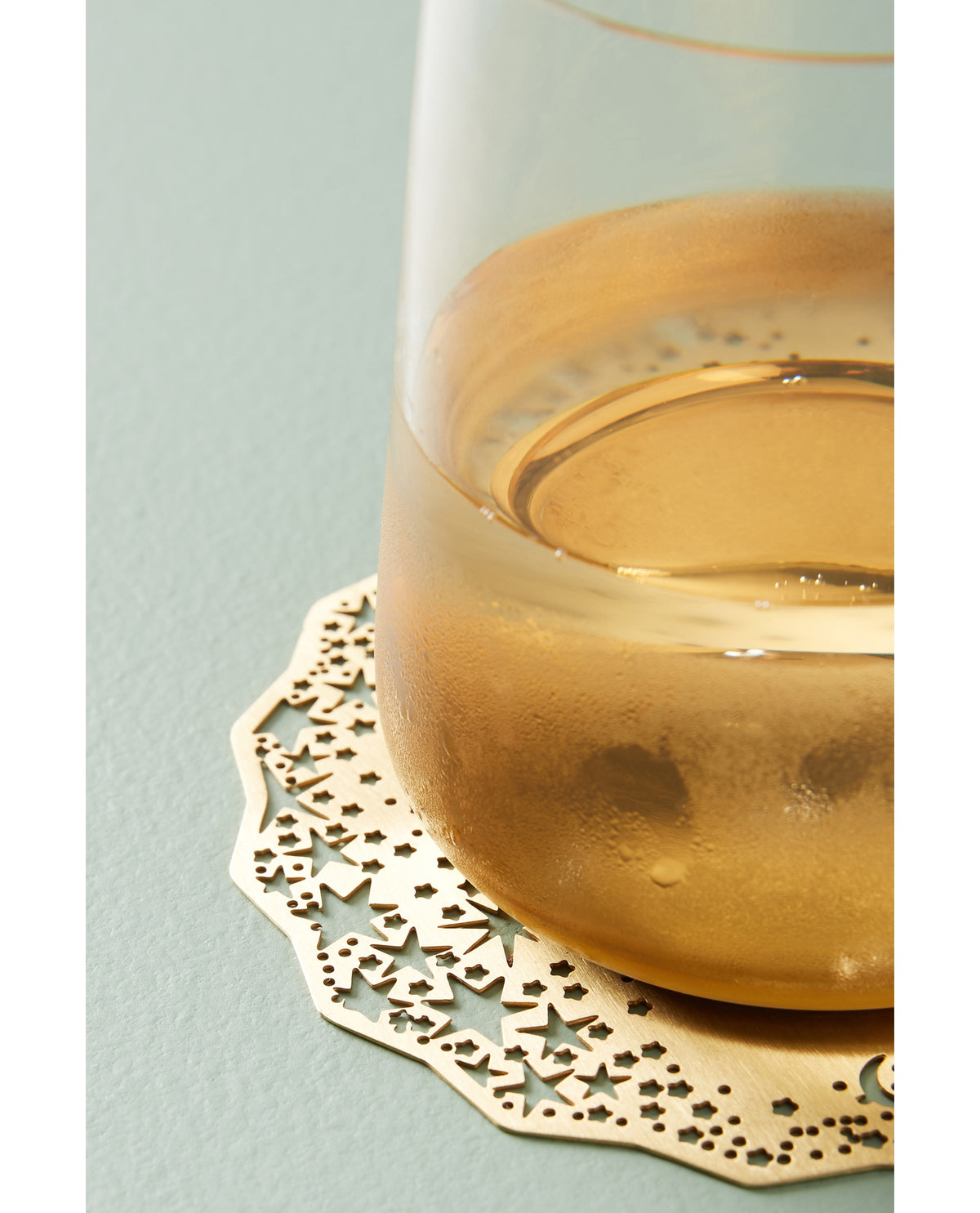 Gold Celestial Coaster under a glass of white wine - Ariana Ost