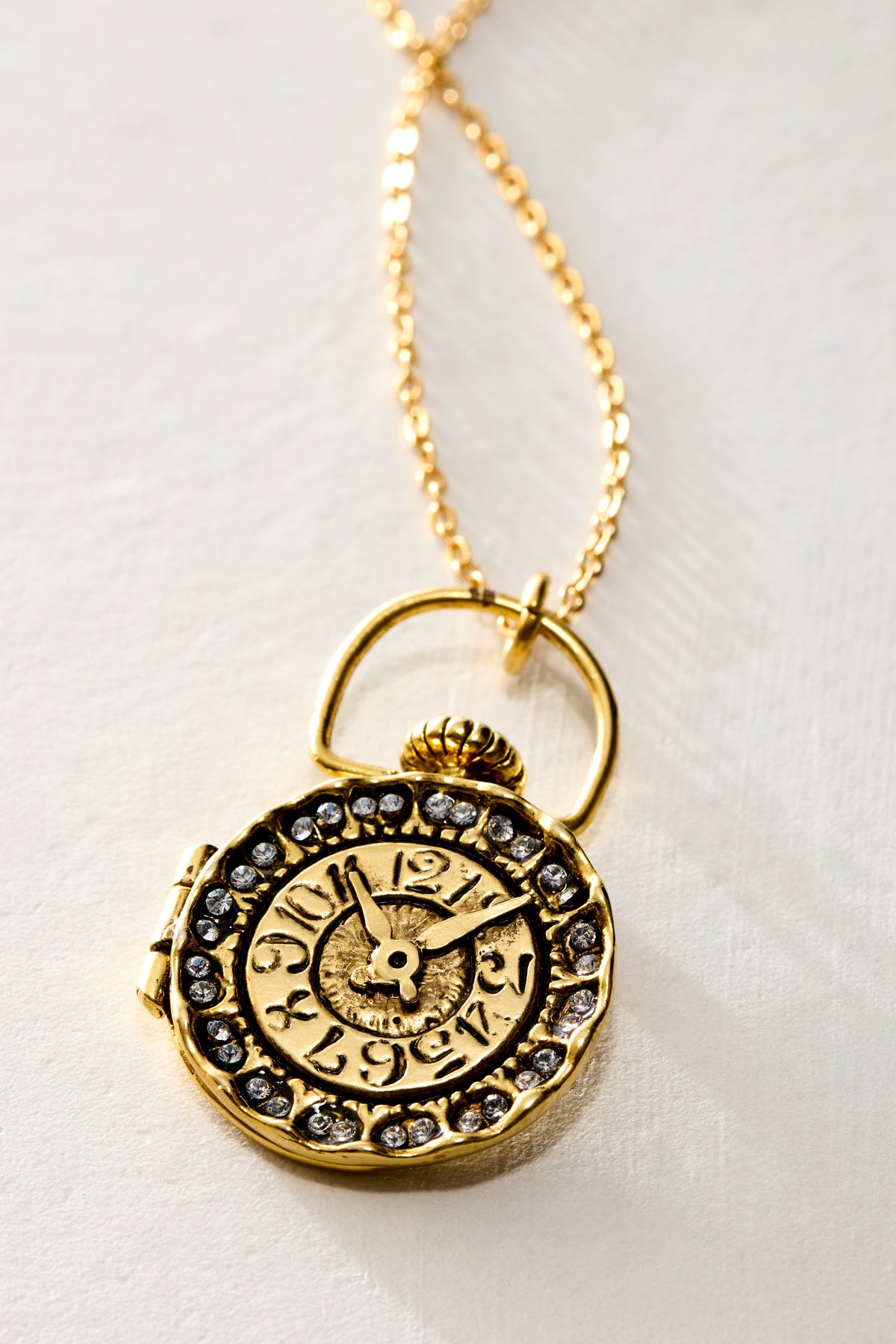 Close-up of the Clock Locket face, with old-world numbers and a ring of Swarovski crystals - Ariana Ost