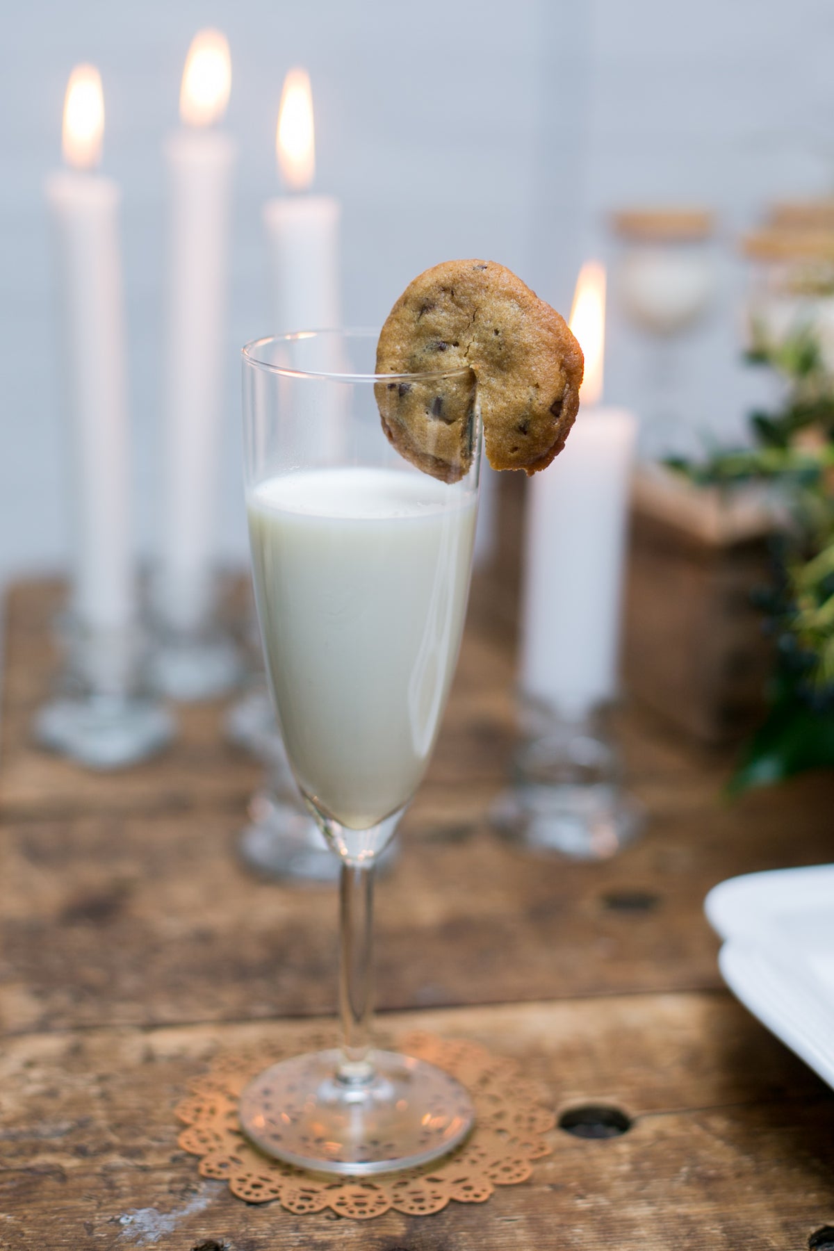 Rose gold Eyelet Doily Coaster under a glass of milk with a chocolate chip cookie - Ariana Ost