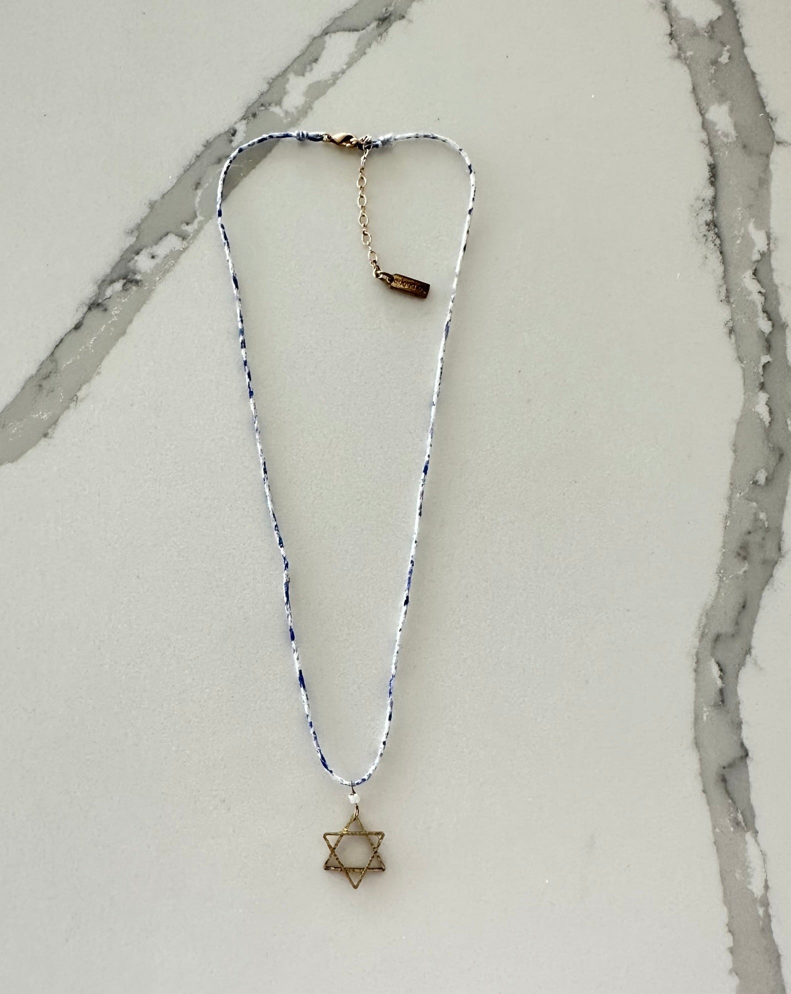 a necklace with a star of david on it
