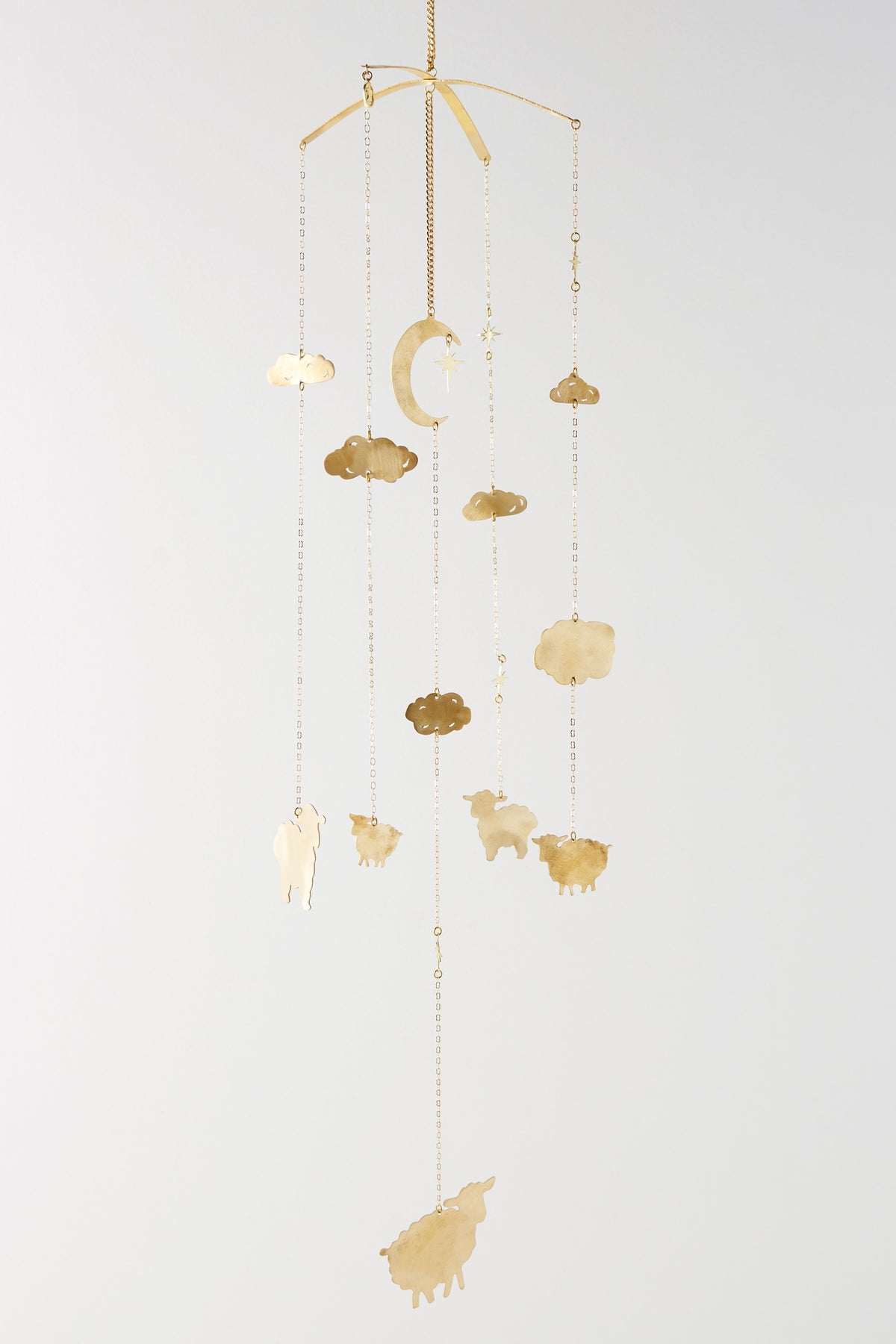 Brass Counting Baby Sheep Mobile hanging in full, with a crescent moon, clouds and leaping sheep on fine chains - Ariana Ost