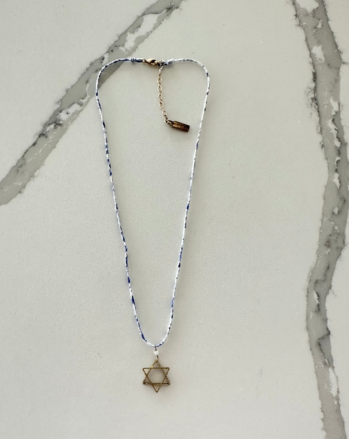 a necklace with a star of david on it