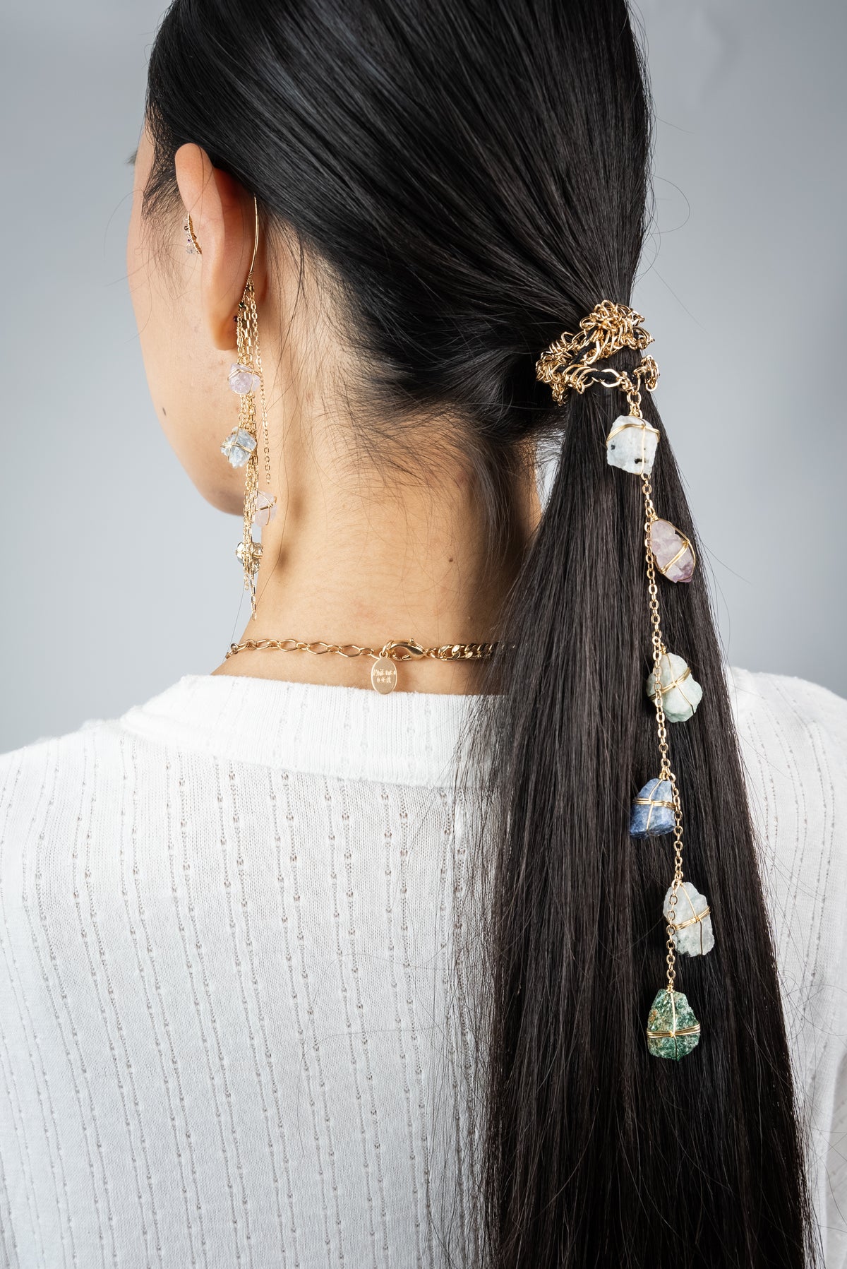 Dripping Stones Crystal Hair Tie, a golden chain of healing crystals cascading through a ponytail - Ariana Ost