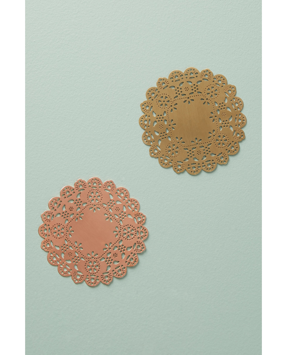 Gold and rose gold Eyelet Doily Coasters on a sage table - Ariana Ost
